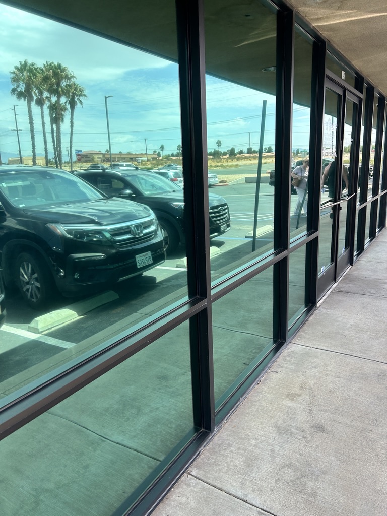Reflective storefront windows and glass entrance doors