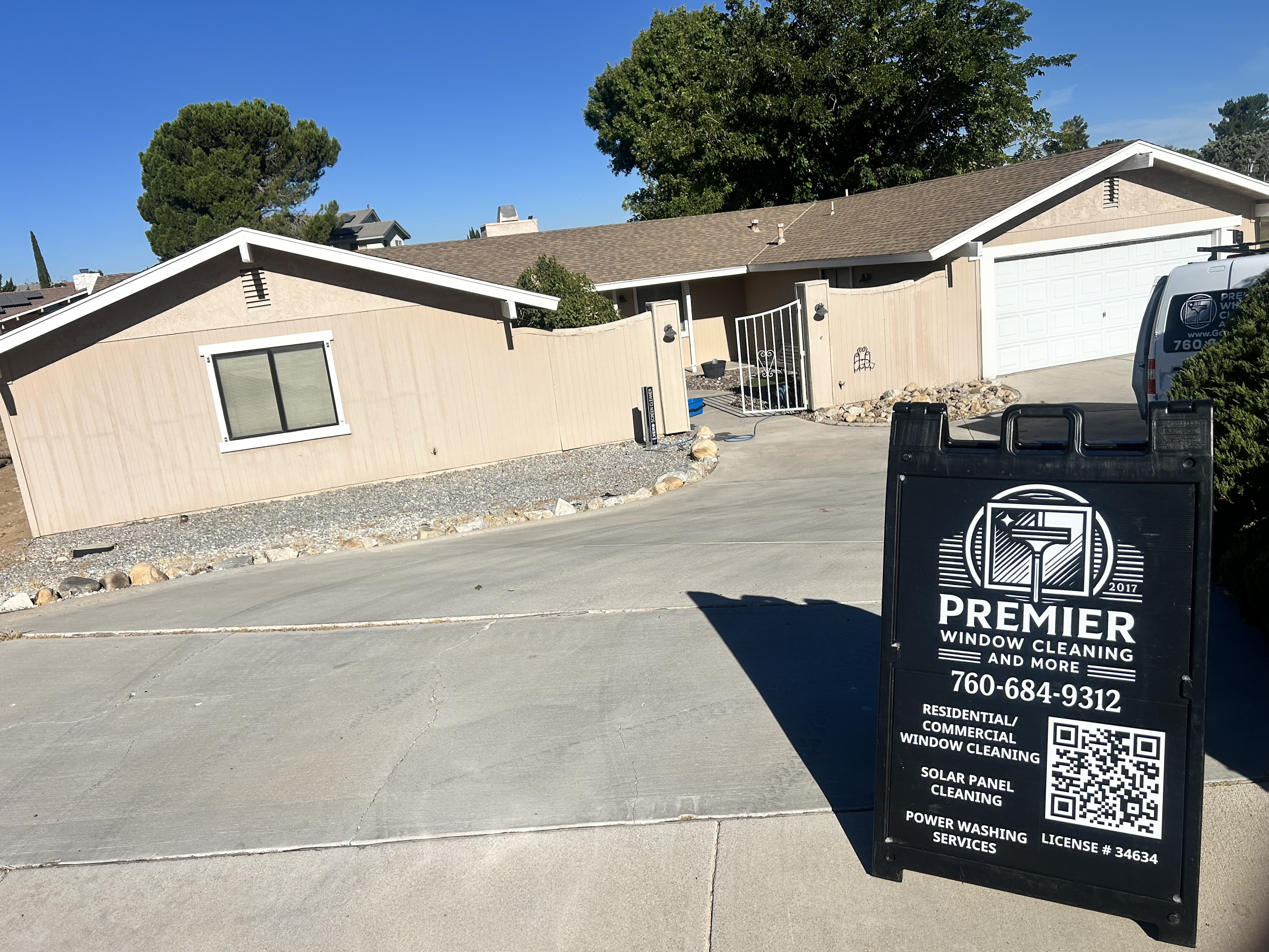 Premier service van and sign outside a single-story home